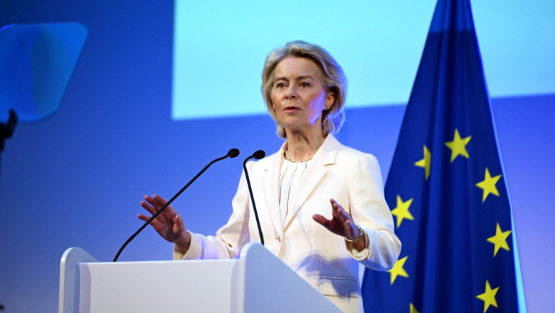 Femeie vorbind la pupitru, steagul Uniunii Europene